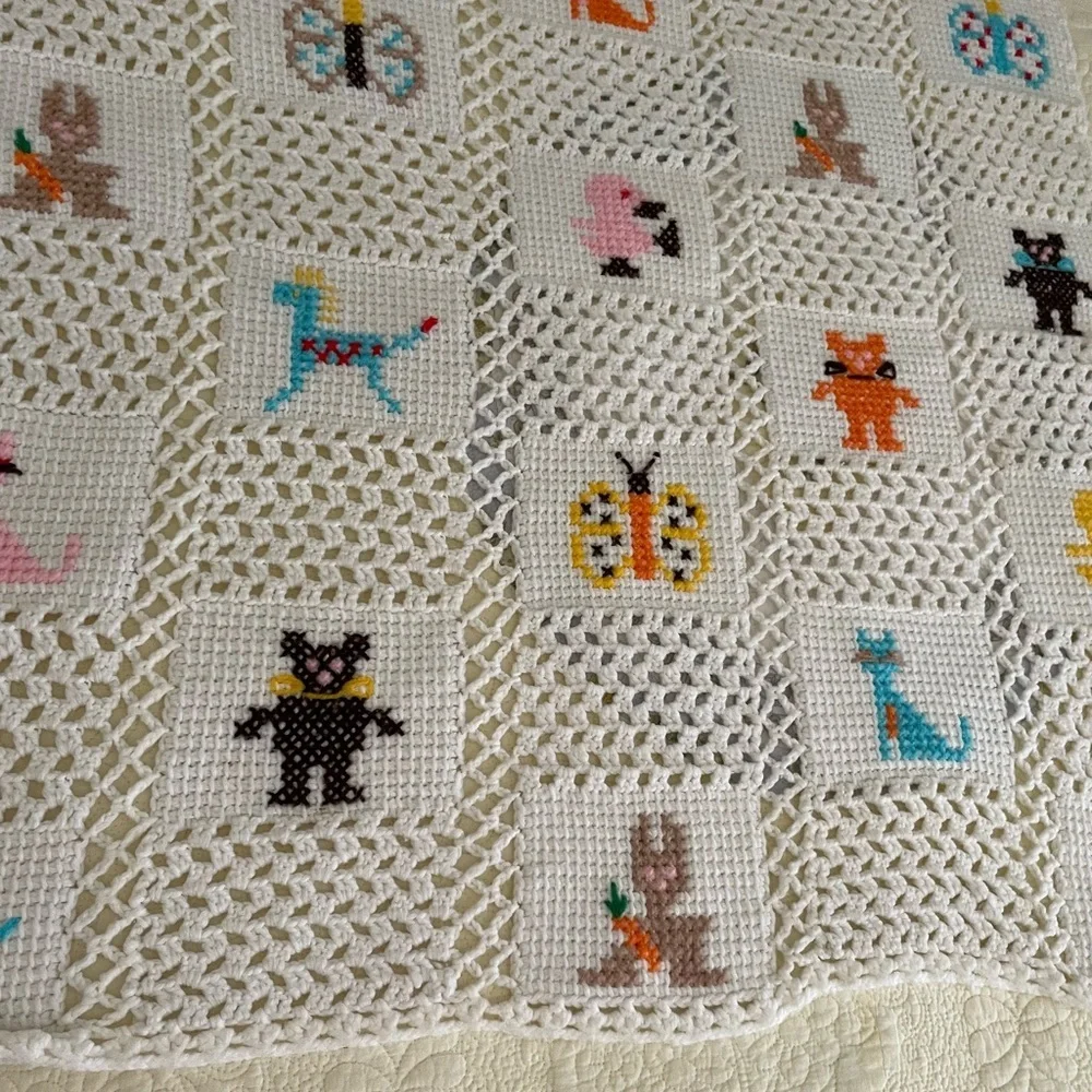 Handmade Crocheted Blanket with Cross Stitch Design, White Background.